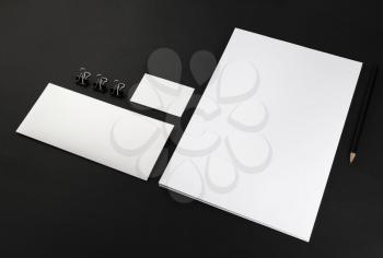 Photo of blank stationery set on black background. Template for design presentations and portfolios. Mock-up for branding identity.