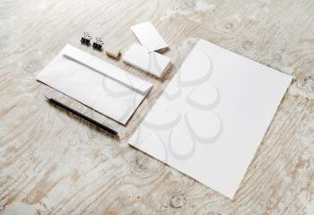Photo of blank stationery set on light wooden background. For design portfolios. Mock-up for your design.