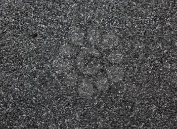 Abstract dark granular background. Abrasive texture roofing material close-up.