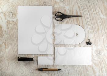 Blank stationery template for design presentations and portfolios. Corporate identity set on light wooden background. Top view.