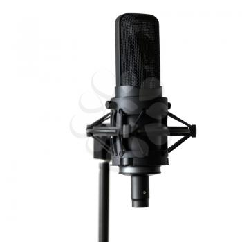 Black microphone on a white background. Shallow depth of field.