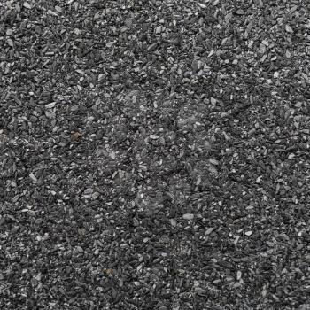 Abrasive texture roofing material close-up. Abstract dark granular background.