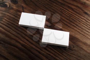 Photo of blank business cards on a wooden table background. Template for ID. Mock-up for your design.