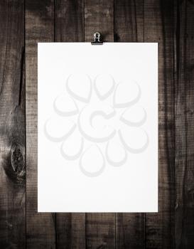 Blank letterhead on vintage wooden table background. White paper poster. Blank paperwork template. Overhead view.