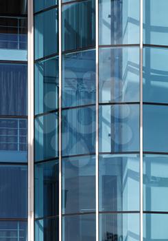 Detail of a modern office building with a glass facade. Vertical shot.
