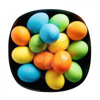 Easter eggs on a black plate. Isolated with clipping path. Top view.