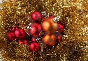 Bright red and orange christmas balls and shiny tinsel