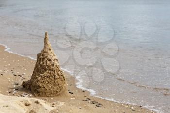 Sand castle, destroyed by the surf. Black Sea coast. Space for text.