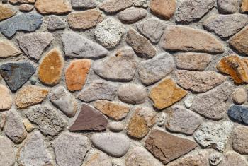 Texture of old stone wall of large boulders.
