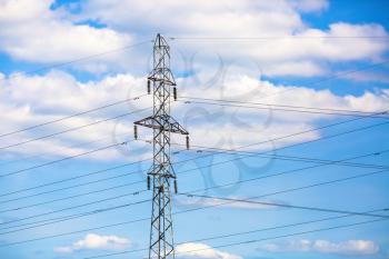Electricity transmission pylon against blue sky. High voltage pylon. Power lines