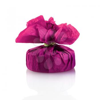 Festive gift box covered with purple paper with reflection on white background. Isolated with clipping path.