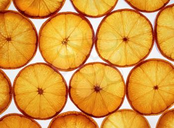 Sliced orange background. Healthy food. Sliced oranges photographed on a gleam.