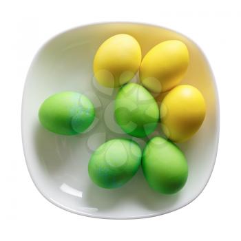 Easter eggs on a white plate. Isolated with clipping path. Top view.