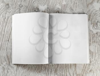 Blank opened book on wooden background. Top view.