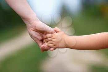 Hands of mother and child. Holding hands. Shallow depth of field.