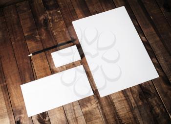 Blank stationery template on vintage wooden table background. Mock-up for branding identity for designers. Top view.