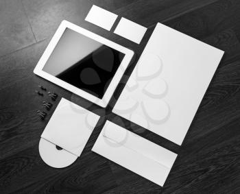 Photo of blank stationery and corporate identity template on dark wooden background. For design presentations and portfolios.