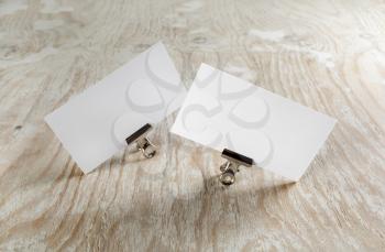 Photo of blank business cards with soft shadow on light wooden background. Template for branding identity.