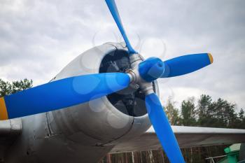 Closeup of propeller and engine of old vintage aircraft. Propeller of retro airplane. Selective focus on propeller.