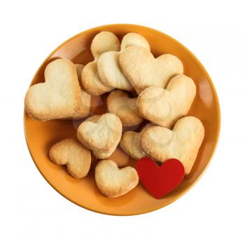 Heart shaped cookies on a ceramic platter. Isolated with clipping path on white background. Top view.