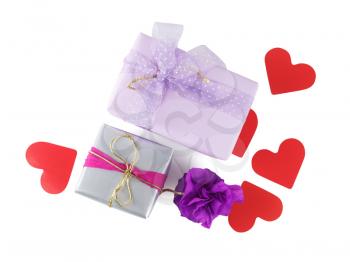 Bright multi-colored gift boxes with paper hearts on a white background. Isolated with clipping path. Top view.