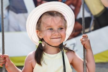 Little girl in a hat smiling. Shallow depth of field.