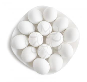 White eggs on a white plate . Clipping path.