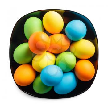 Colored Easter eggs on a black plate. Clipping path.