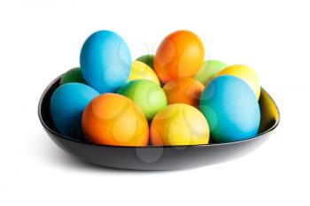 Colorful Easter eggs on a black plate. 