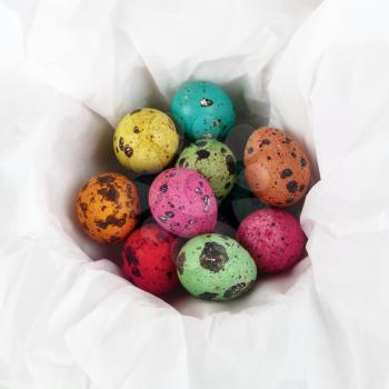 Colored Easter eggs on white background of wrapping paper. Top view.