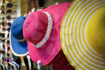 Colored women's hats with a wide brim. Shallow depth of field. Selective focus.