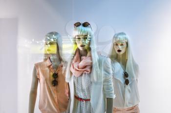 Fashion concept. Photo of three elegant female mannequins showing clothing and accessories.