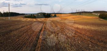 Field after harvest. Rural landscape at sunset. Plowed field.