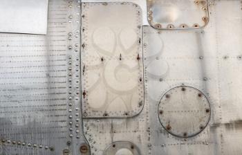 Abstract metal texture. Weathered vintage metal background with rivets . Sheathing old airplane.