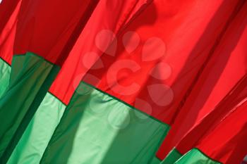 Abstract of the fabric. Red-green flags fluttering in the wind.