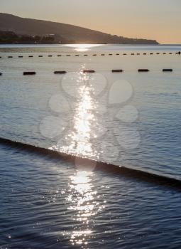 Reflection of the sun in the morning on the sea. Vertical shot.