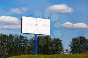 Blank billboard on blue sky background. Blank street poster. For design presentations and portfolios. Shallow depth of field. Selective focus.
