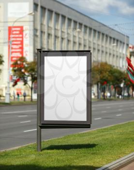 Blank vertical billboard on the street. Clipping path. Shallow depth of field.