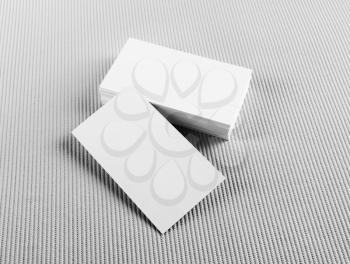 Photo of blank business cards with soft shadows on gray background. Mock-up for branding identity.
