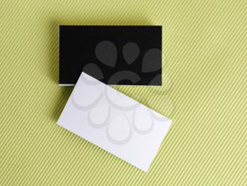 Blank black and white business cards on a green background. Template for ID.  Isolated with clipping path. Top view.