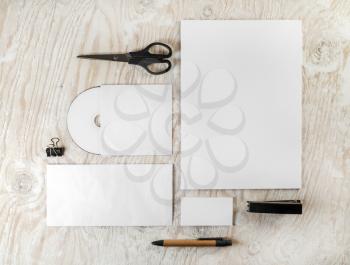 Photo of blank stationery set on light wooden background. Mockup for branding identity.