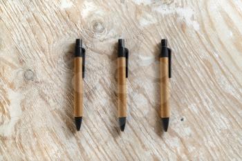 Set mechanical ballpoint pens on a wooden background. Template for design presentations and portfolios. Studio shot.