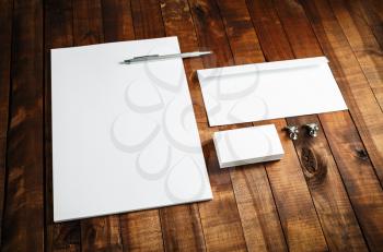 Blank stationery set. Corporate identity template on wooden table background. Letterhead, business cards, envelope and pen. Mock-up for branding identity.
