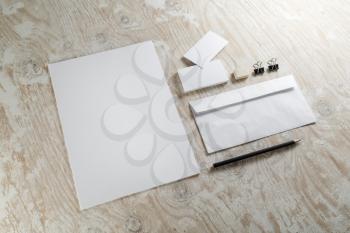 Photo of blank stationery set. Corporate identity template on light wooden background. For design presentations and portfolios.