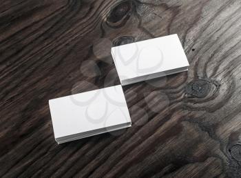 Photo of blank business cards on wooden background. Blank template for design presentations and portfolios.