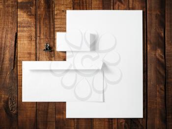 Blank stationery and corporate identity template on wooden table background. For design presentations and portfolios. Top view.