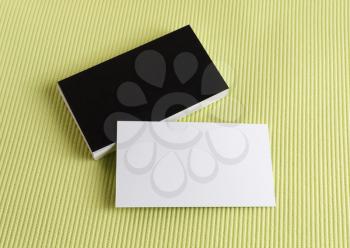 Blank black and white business cards on a green background. Template for branding identity.