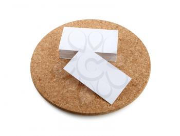 Blank business cards on a round cork base.  Isolated with clipping path. Top view.