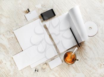 Photo of blank stationery. Corporate identity template on light wooden background. For design presentations and portfolios. Top view. 