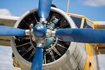 Propeller and aircraft engine closeup. Front view. Shallow depth of field.